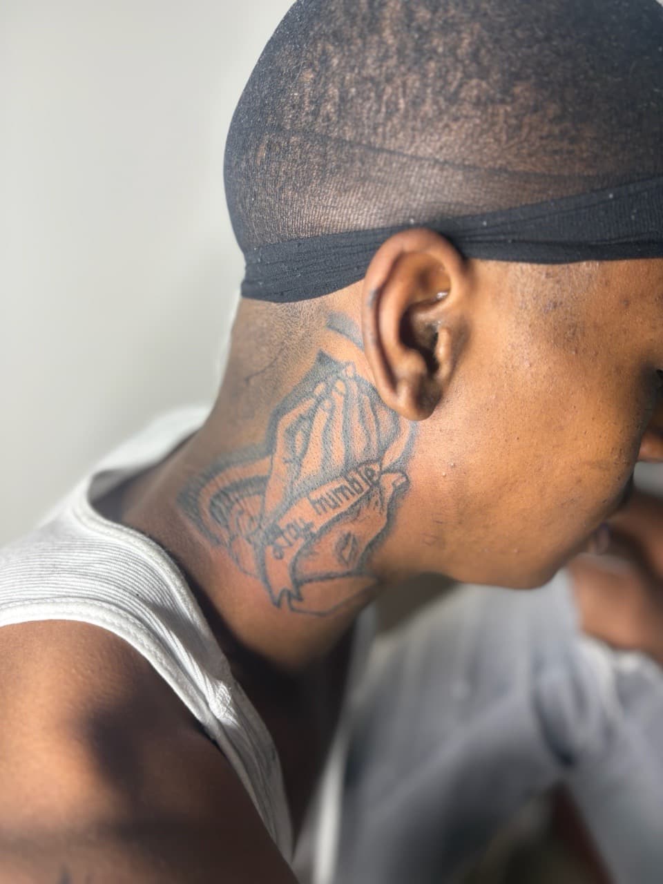 Black & Grey + Lettering praying hands tattoo on Neck (Side) by 3inkd on TattMe