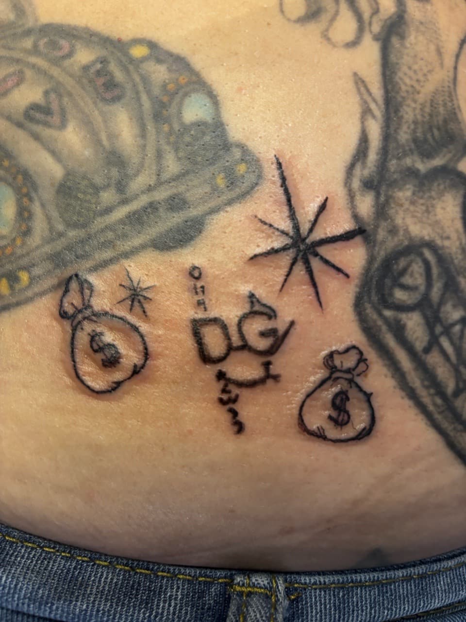Stick & Poke + Fine Line money bags tattoo on Lower Back by Mr_I_Can_Do_Tattoos on TattMe