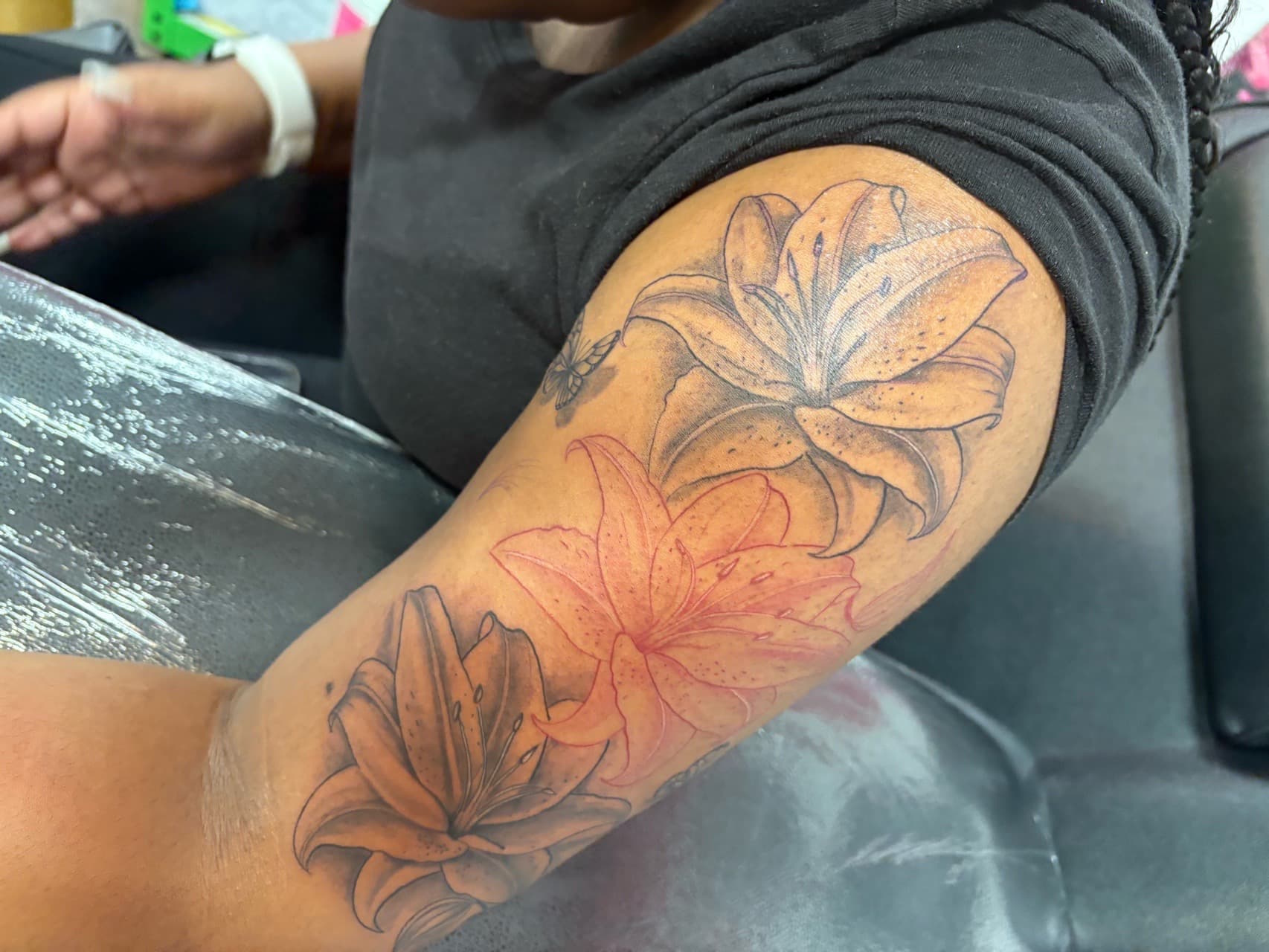 Floral + Black & Grey lilies tattoo on Upper Arm by inkstains_tattoo_studio on TattMe