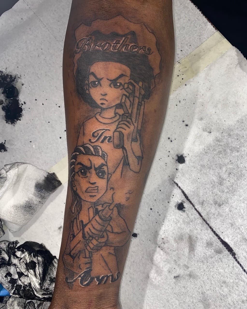 Illustrative + Black & Grey boondocks tattoo on Forearm by 4oeMag_Tattoos on TattMe