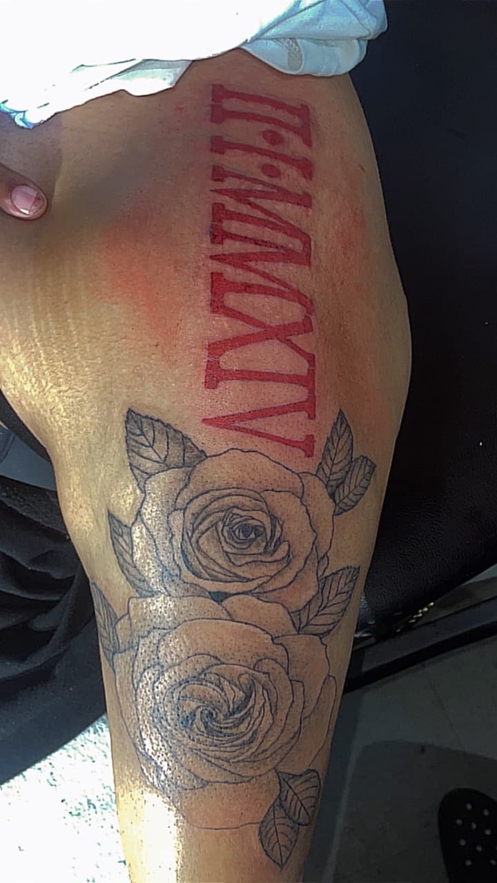 Floral + Lettering roman numerals tattoo on Thigh by 4oeMag_Tattoos on TattMe