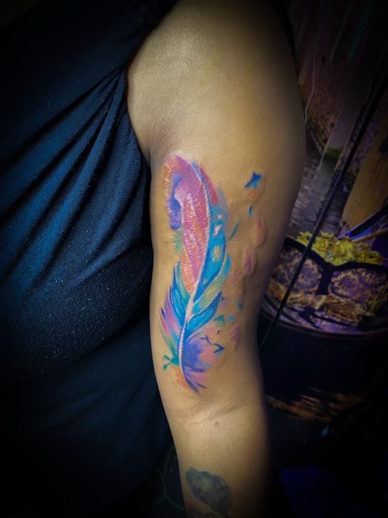 Watercolor + Color feather tattoo on Upper Arm by TNO_INK on TattMe