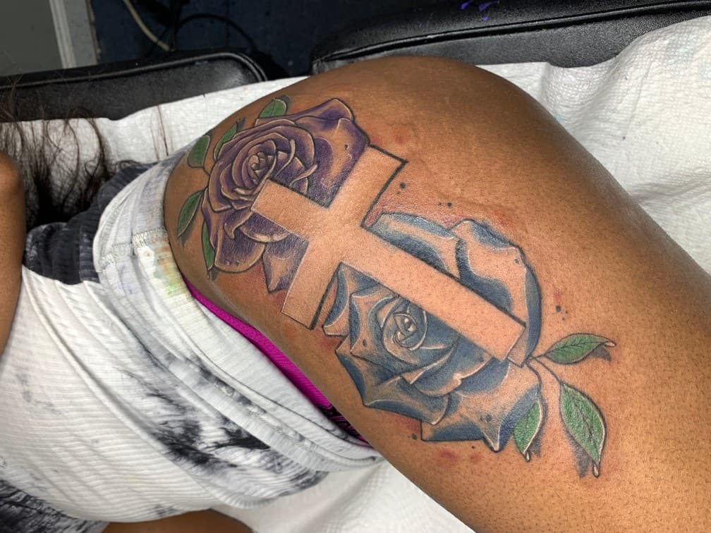 Color + Floral cross tattoo on Thigh by Torian_Benns on TattMe