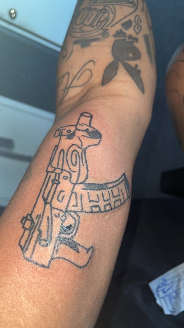 Line-work + Black-work gun tattoo on Upper Arm by Syd_tattoos on TattMe