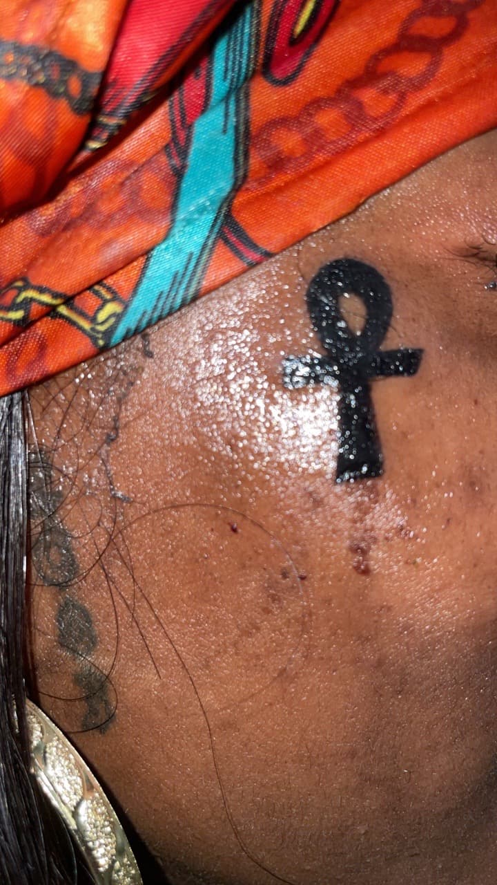 Black-work + Minimalist ankh tattoo on Face by Syd_tattoos on TattMe