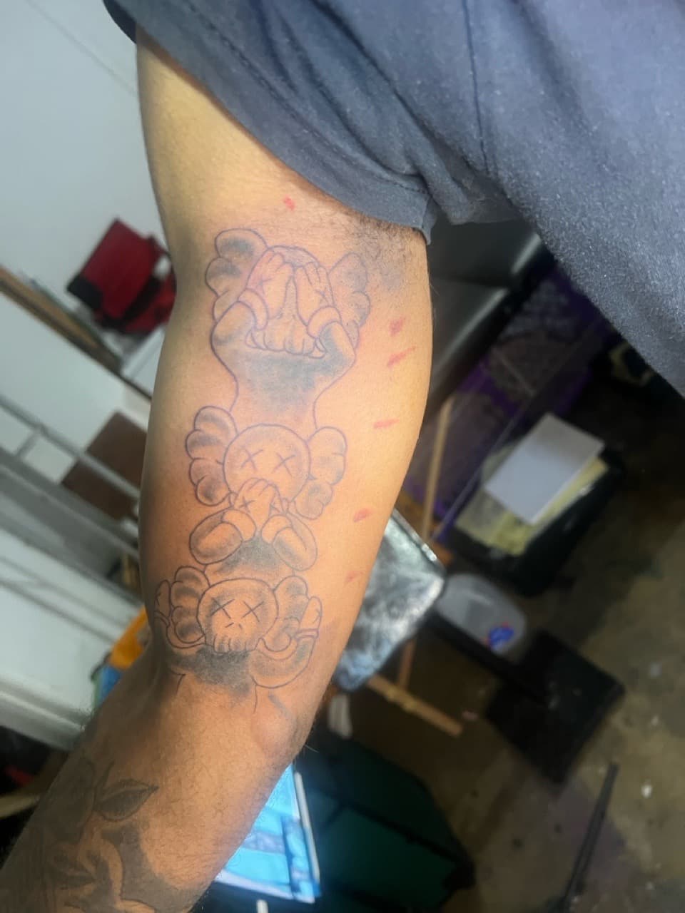 Black & Grey + Pop Culture kaws tattoo on Upper Arm by Twan_Ink on TattMe