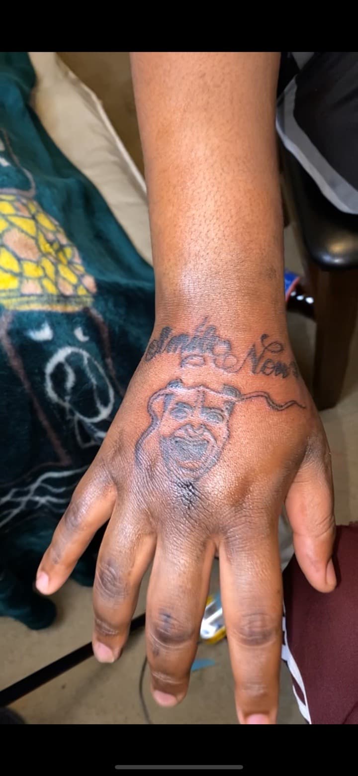 Black & Grey + Lettering mask tattoo on Hand by Quis on TattMe