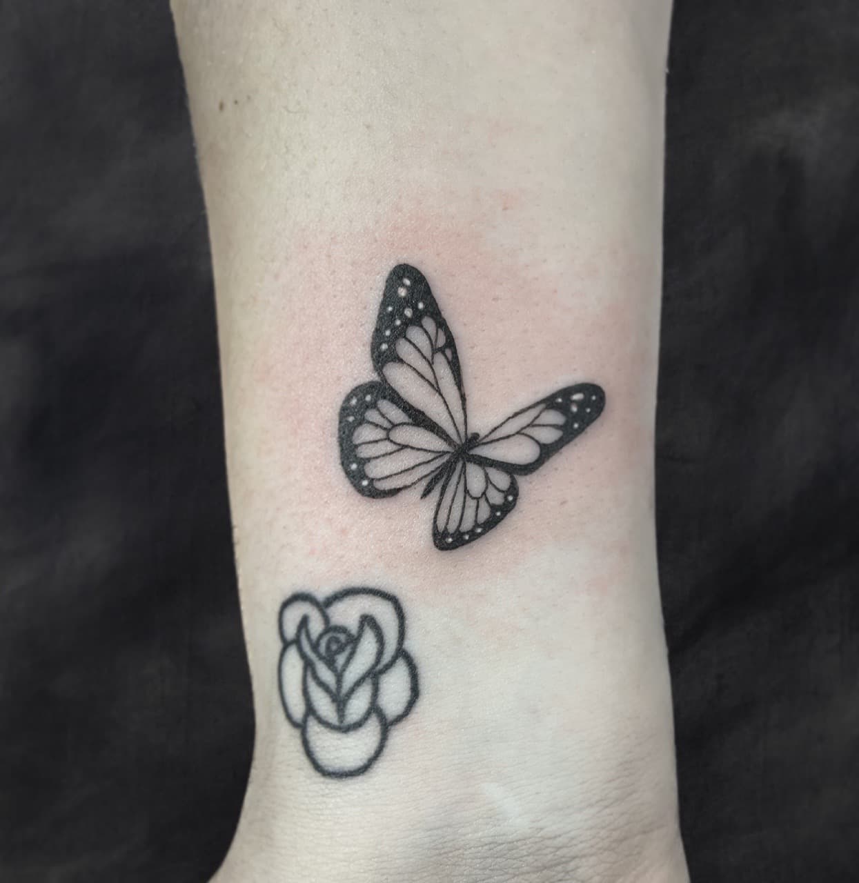 Fine Line + Black & Grey butterfly tattoo on Wrist by Adriana on TattMe