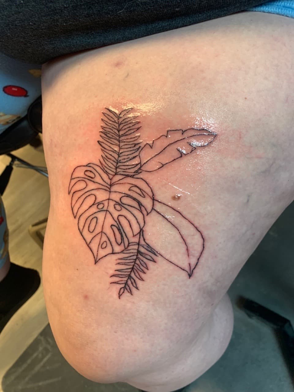Fine Line + Black-work monstera tattoo on Thigh by Fishbonez_Tattoo on TattMe