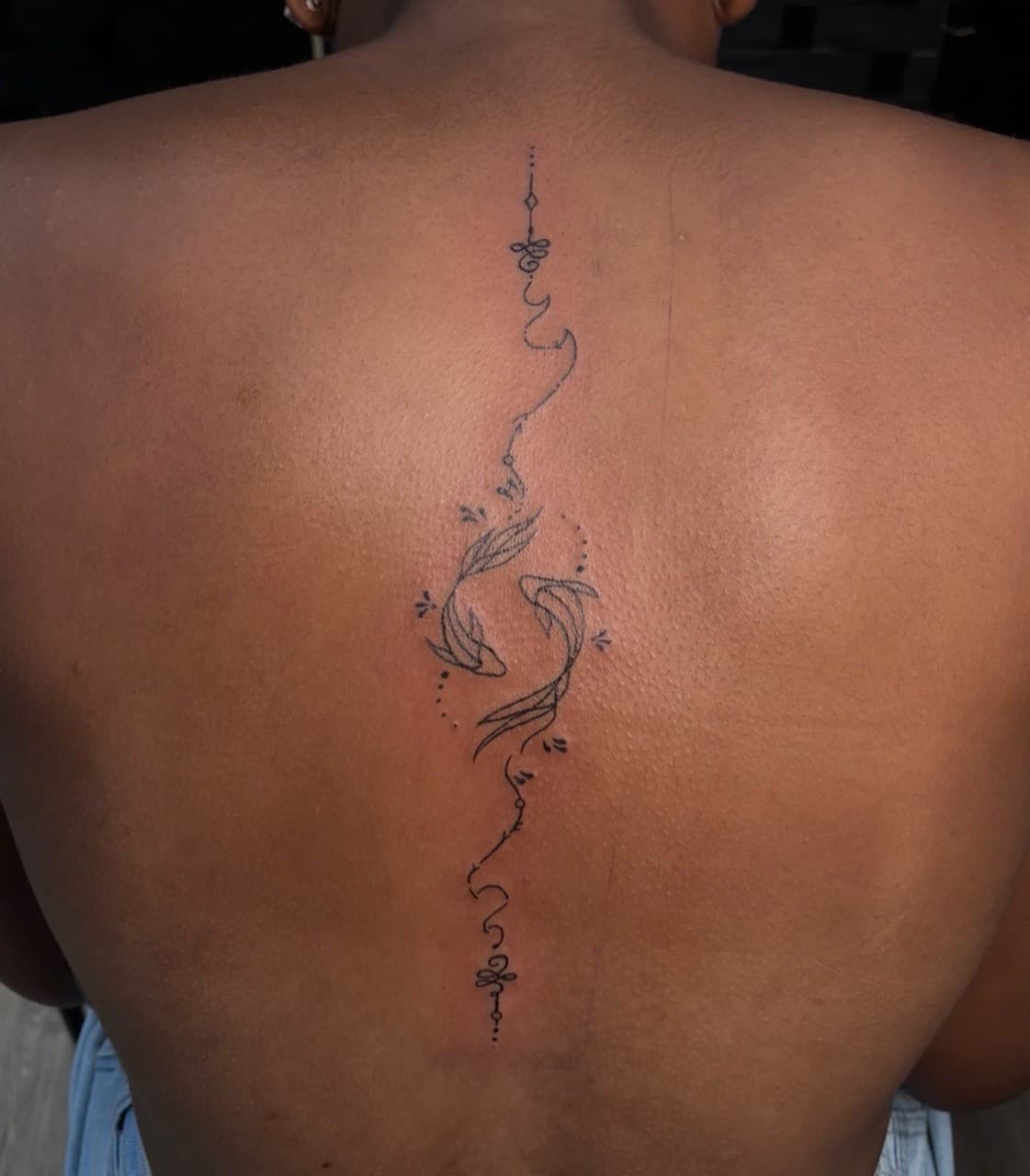 Fine Line + Black-work koi fish tattoo on Spine by Jniceinkz on TattMe