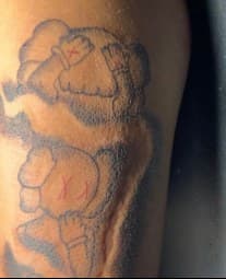 Pop Culture + Black-work kaws tattoo on Thigh by Diorrvee on TattMe