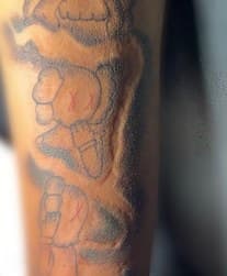 Line-work + Pop Culture kaws tattoo on Upper Arm by Diorrvee on TattMe