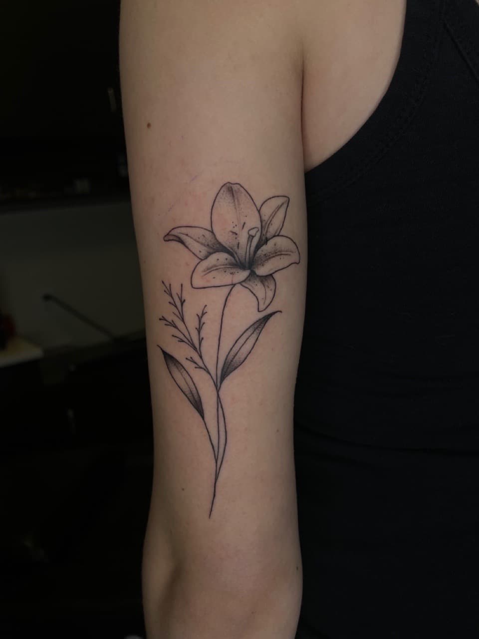 Floral + Fine Line lily tattoo on Upper Arm by Dark_Alchemy_Studios on TattMe