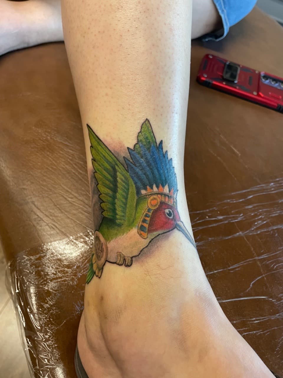 Color + Illustrative hummingbird tattoo on Ankle by Dark_Alchemy_Studios on TattMe