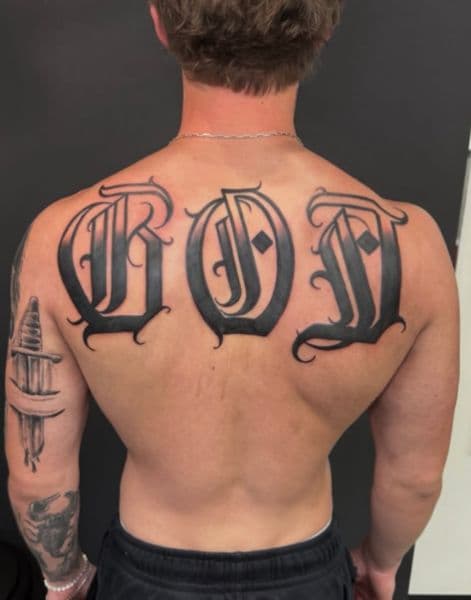 Lettering + Black-work god tattoo on Upper Back by Wraithtattoos on TattMe