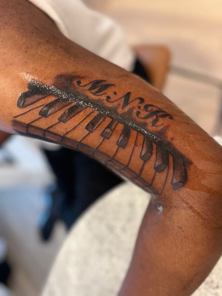 Black & Grey + Lettering piano tattoo on Upper Arm by LV on TattMe