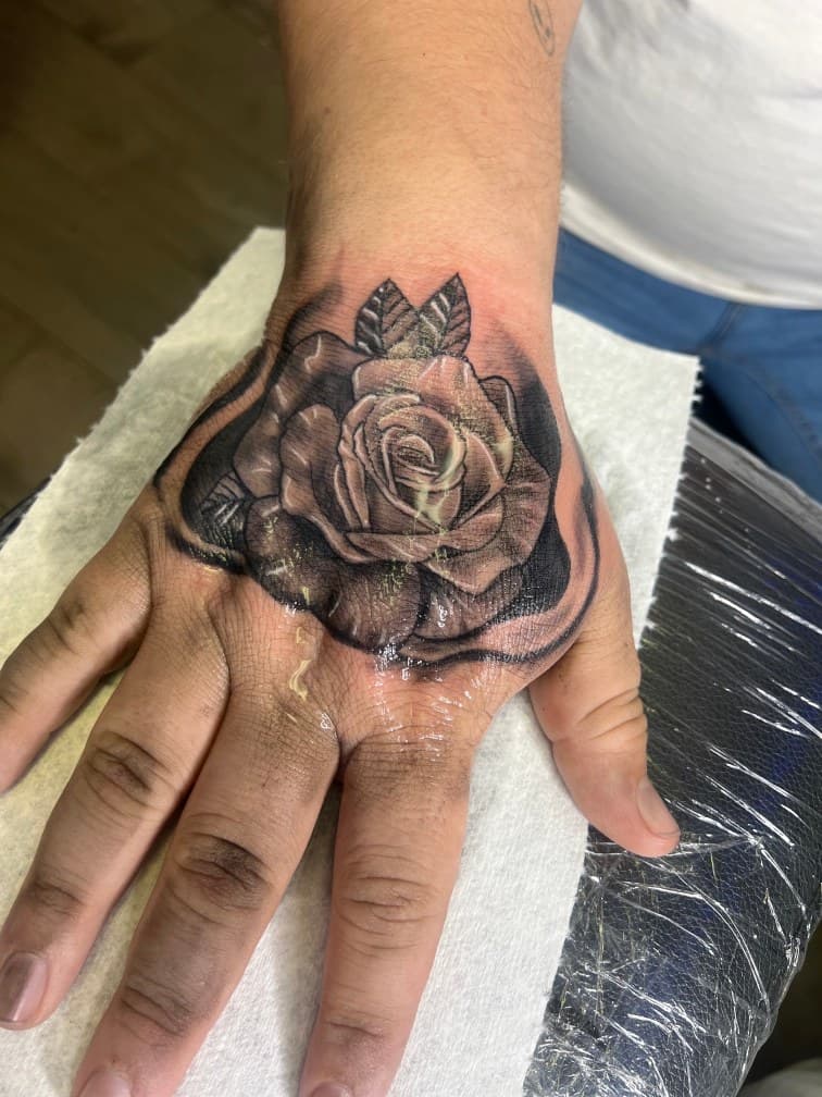 Black & Grey + Floral rose tattoo on Hand by LV on TattMe