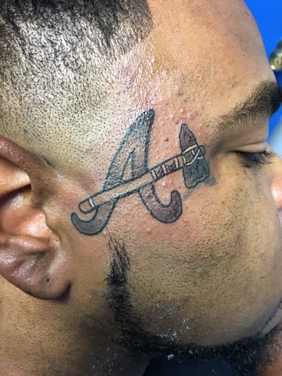 Black-work logo tattoo on Face by all_saints_social on TattMe