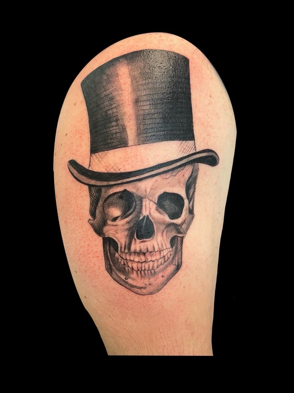 Black & Grey + Realism skull tattoo on Upper Arm by all_saints_social on TattMe
