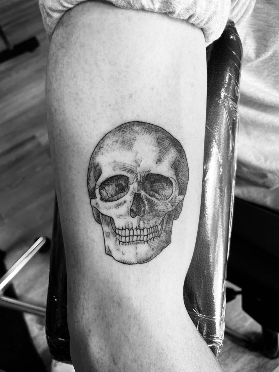 Black & Grey + Illustrative skull tattoo on Upper Arm by all_saints_social on TattMe