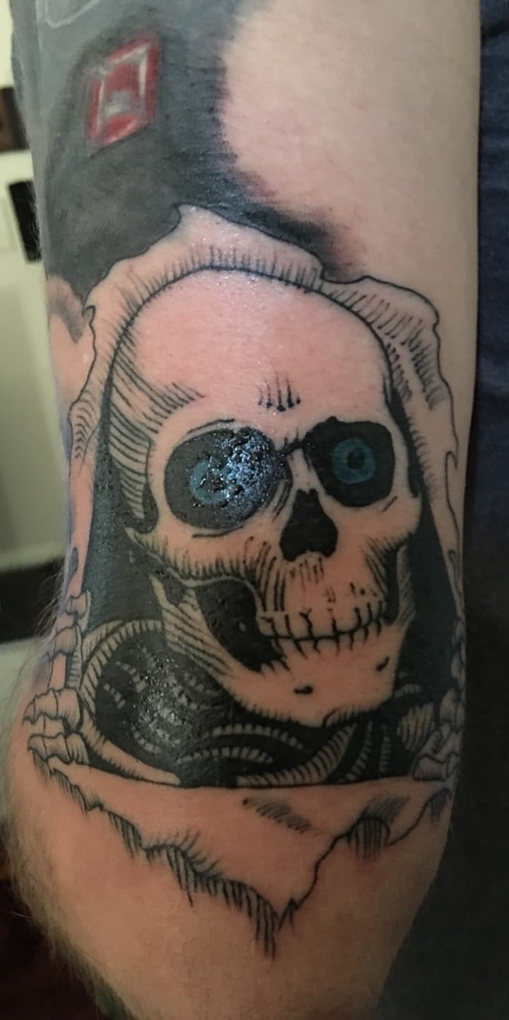 Black & Grey + Illustrative skull tattoo on Upper Arm by all_saints_social on TattMe