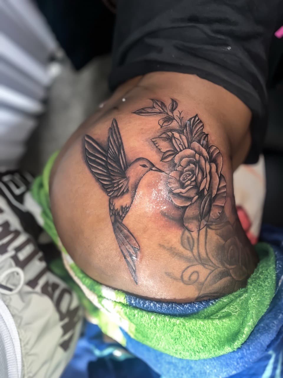 Black & Grey + Floral hummingbird tattoo on Lower Back by staylitink on TattMe
