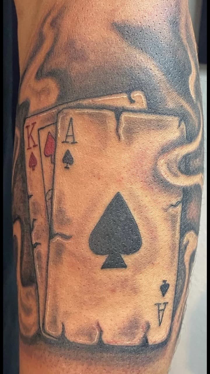 Black & Grey + Illustrative playing cards tattoo on Upper Arm by Soul_Artist_Ink on TattMe