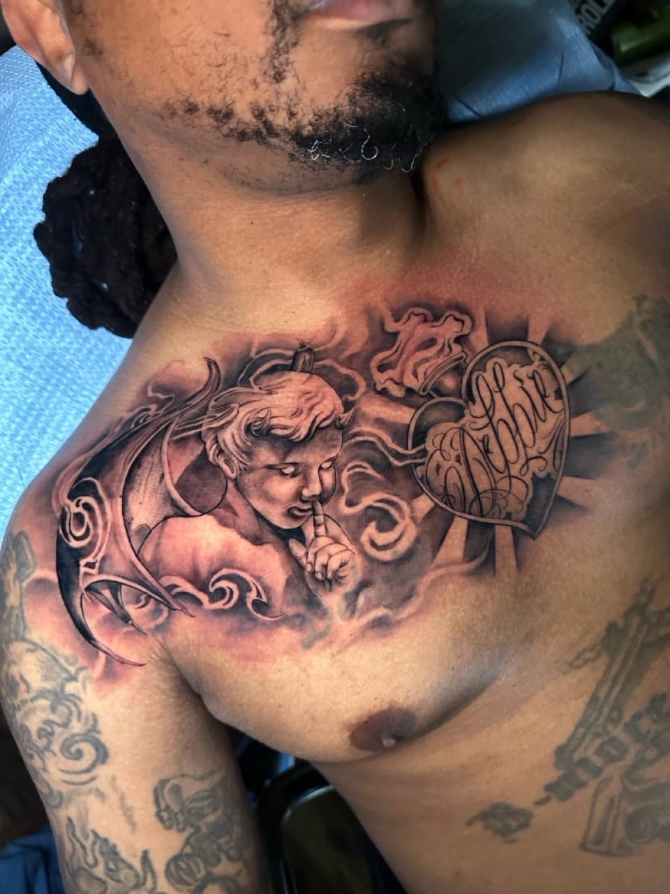 Black & Grey + Realism cherub tattoo on Chest by Cael_Tattoos on TattMe
