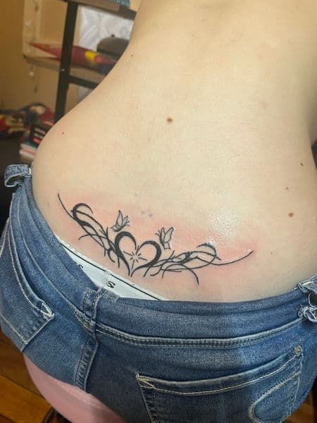 Black-work + Line-work heart tattoo on Lower Back by InkedByNaireea on TattMe