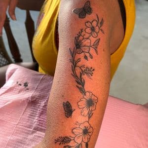 Minimalist flowers tattoo on Upper Arm by InkedByNaireea on TattMe