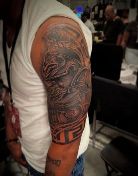 Black-work + Color spartan helmet tattoo on Upper Arm by Inked_By_Tk on TattMe