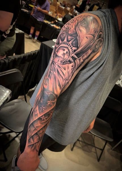 Black & Grey + Realism statue of liberty tattoo on Full Sleeve by Inked_By_Tk on TattMe