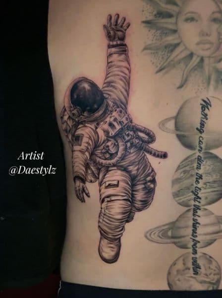 Black & Grey + Illustrative astronaut tattoo on Ribs by STYLZINK on TattMe