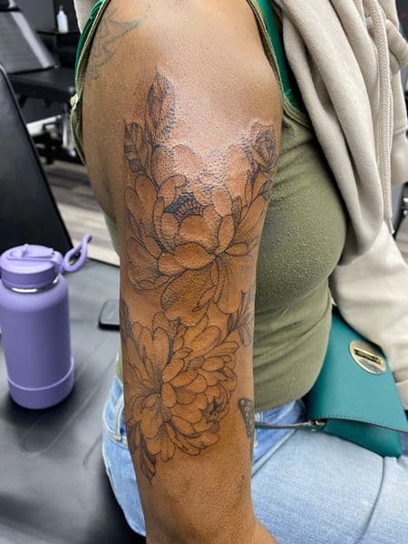 Floral + Illustrative flowers tattoo on Upper Arm by Trill.Tattoos on TattMe