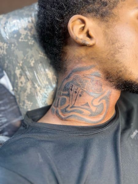 Black & Grey + Illustrative playing cards tattoo on Neck (Side) by Overall_Ink on TattMe
