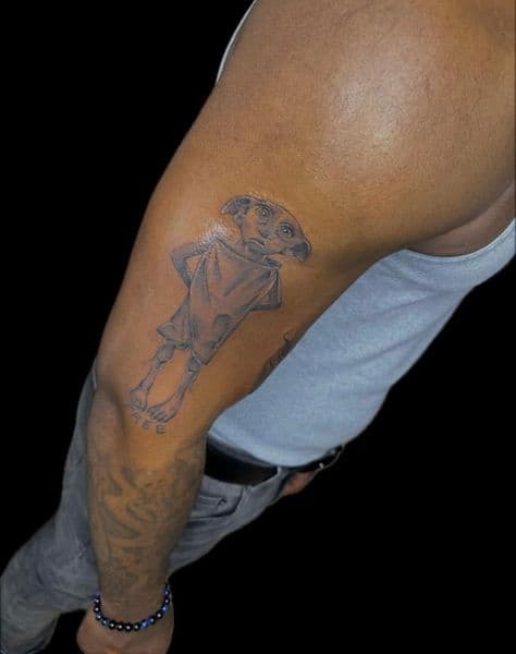 Black & Grey + Illustrative dobby tattoo on Upper Arm by Najah_Padilla on TattMe