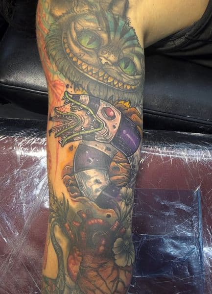 Color + Illustrative cheshire cat tattoo on Half Sleeve by Luc_Baker on TattMe