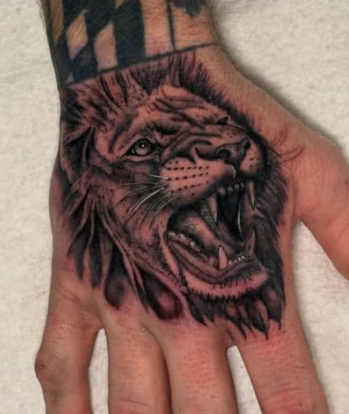 Black & Grey + Realism lion tattoo on Hand by InkByWayne on TattMe