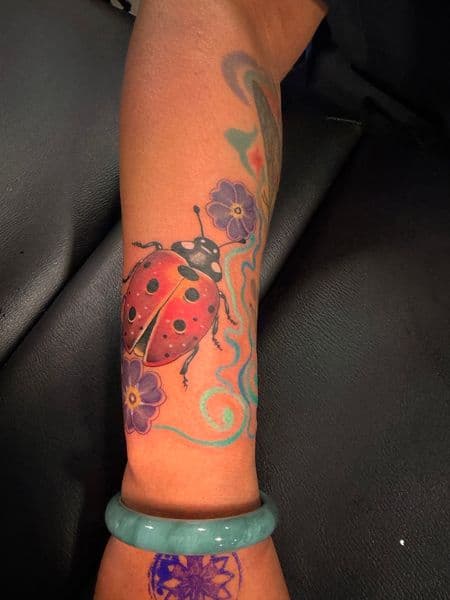 Color + Illustrative ladybug tattoo on Forearm by Kiwi on TattMe