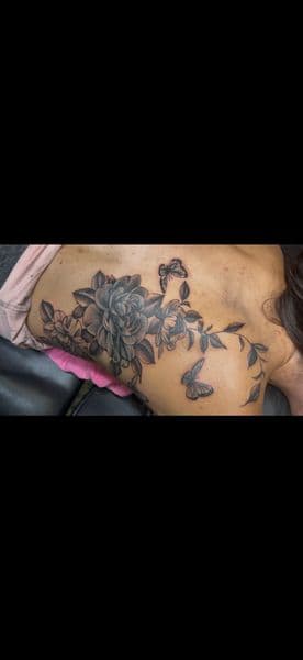 Black & Grey + Floral flowers tattoo on Upper Back by InkedbyJunior on TattMe