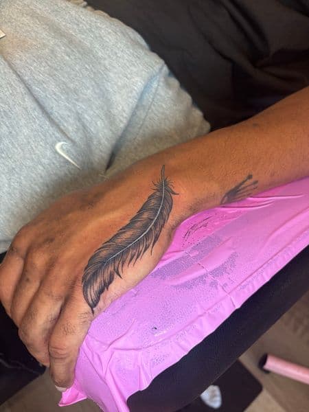 Fine Line + Black & Grey feather tattoo on Hand by tatsby_sos on TattMe