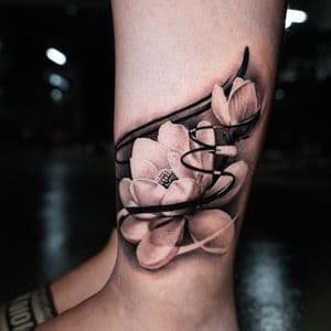 Surrealism + Black & Grey lotus tattoo on Calf by TATMANERC on TattMe
