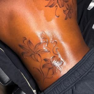 Floral + Black & Grey lilies tattoo on Upper Back by tattoo.banditt on TattMe