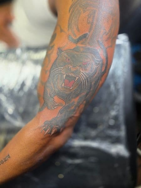 Black & Grey + Illustrative panther tattoo on Upper Arm by Qjoriginals43 on TattMe