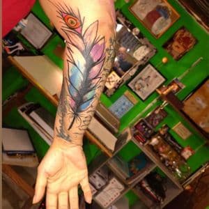 Watercolor + Illustrative feather tattoo on Forearm by nomad_ink on TattMe