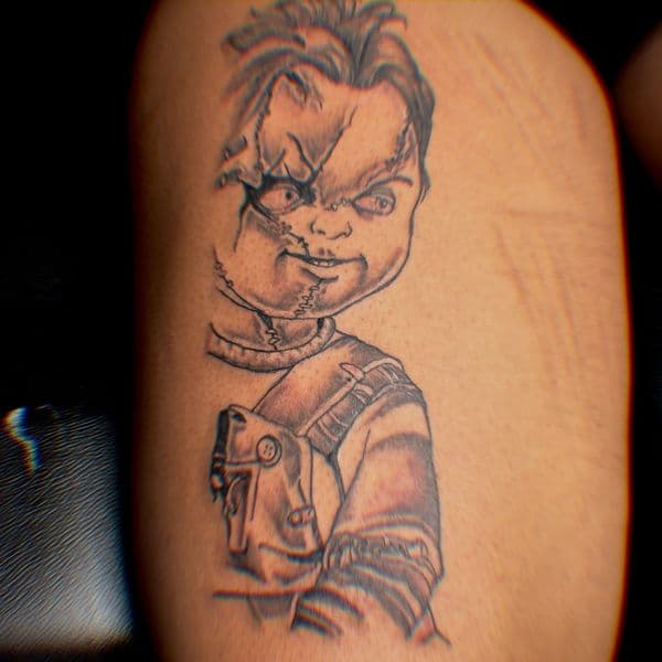 Black & Grey + Illustrative chucky tattoo on Upper Arm by Murda_Innk on TattMe