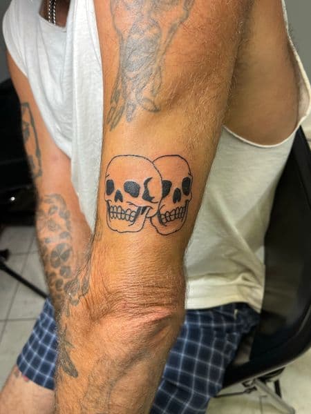 Traditional + Black-work skulls tattoo on Upper Arm by inksfromkels on TattMe