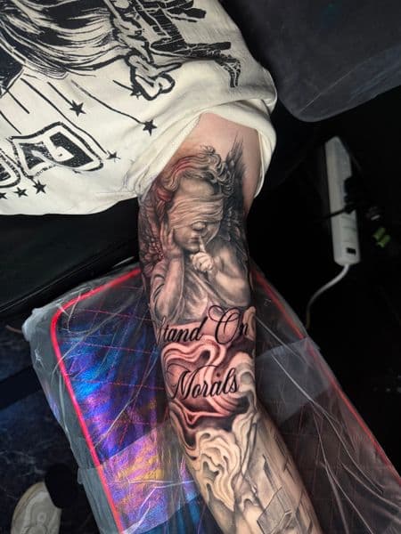 Realism + Black & Grey angel tattoo on Upper Arm by nayasTats on TattMe
