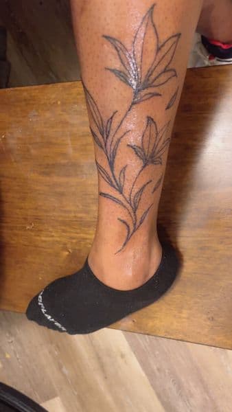 Floral + Fine Line flowers tattoo on Calf by TattsByNaee on TattMe