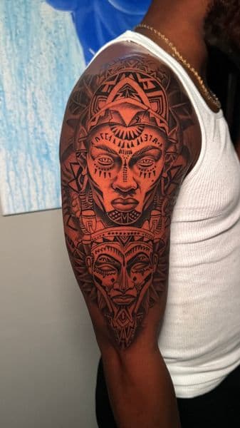 Black-work + Tribal faces tattoo on Upper Arm by ARTWORLDINK on TattMe